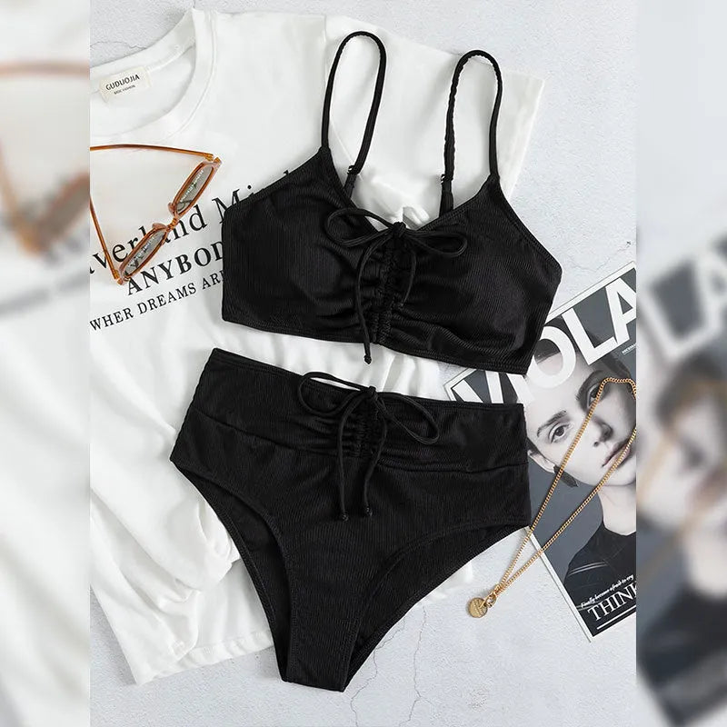 Black women's bikini swimsuit with high-waist shorts and sling split design.
