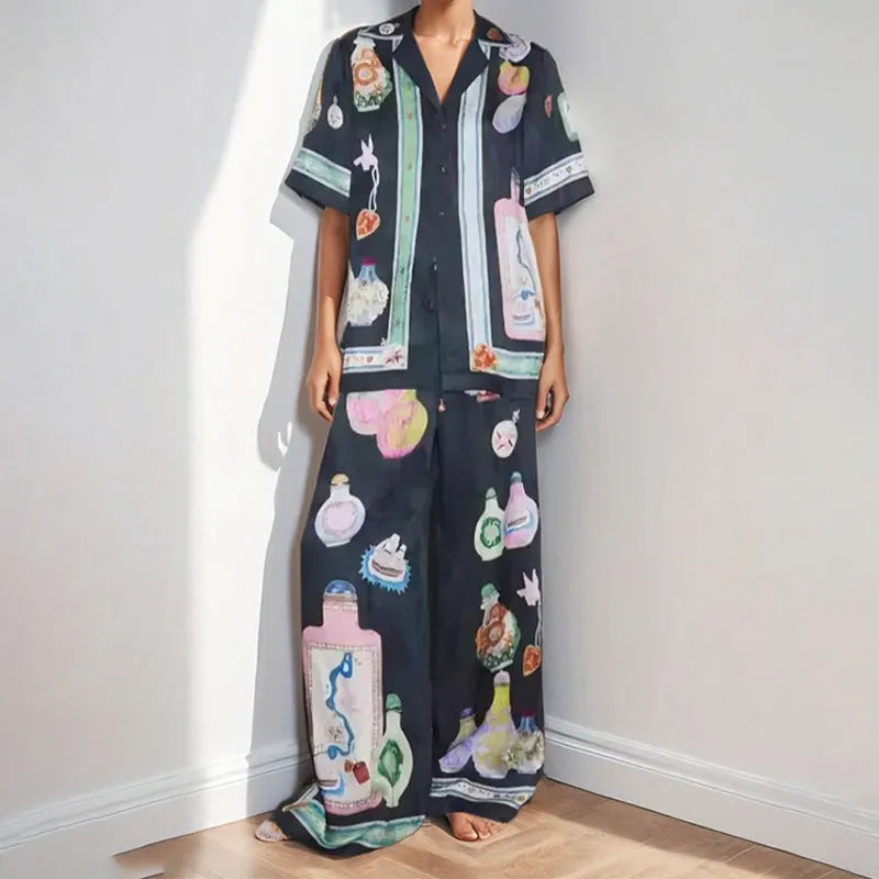 Women's black polyester co-ord set with cartoon animation print showing cardigan and trousers