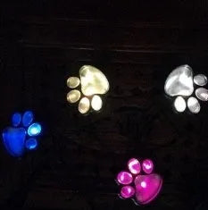 Black solar powered bear paw print garden lights with four paw shapes