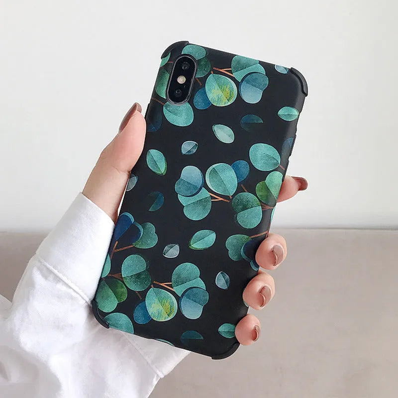 Black silicone iPhone case with a detailed raised leaf pattern design on the back.