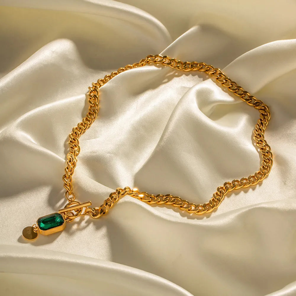 Gold electroplated titanium steel necklace with emerald zircon geometric pendant on Cuban link chain