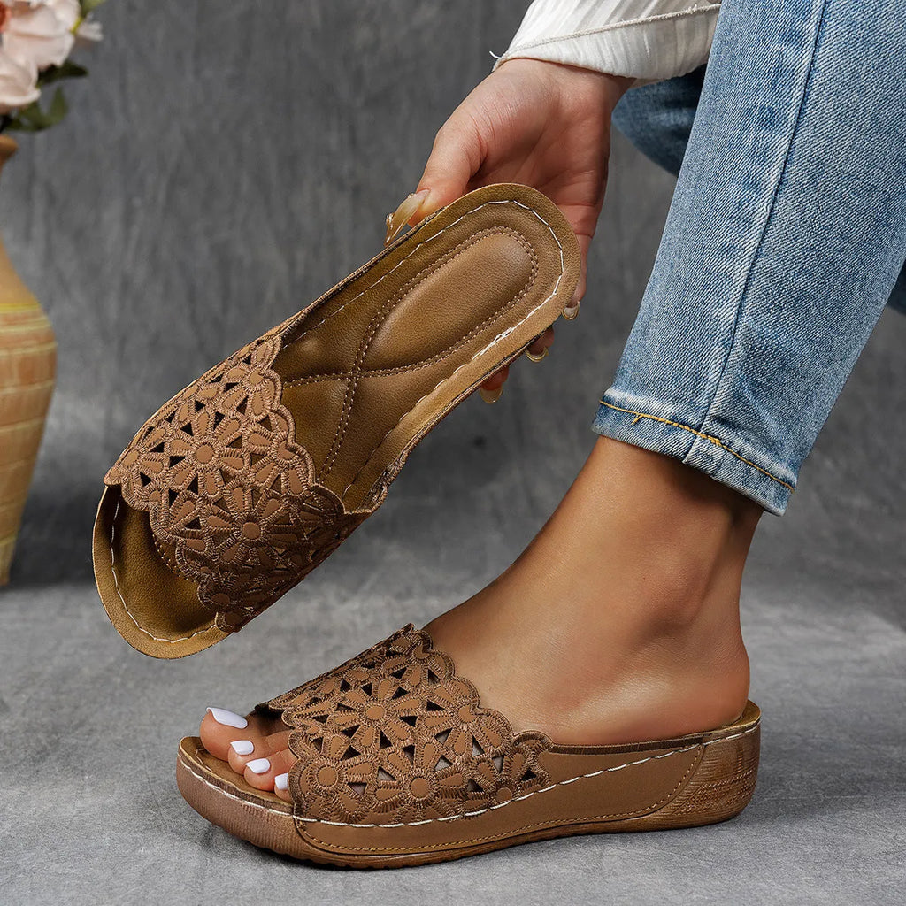 Women's wedge beach slippers with flower cutout design in PVC material showing fish mouth toe shape