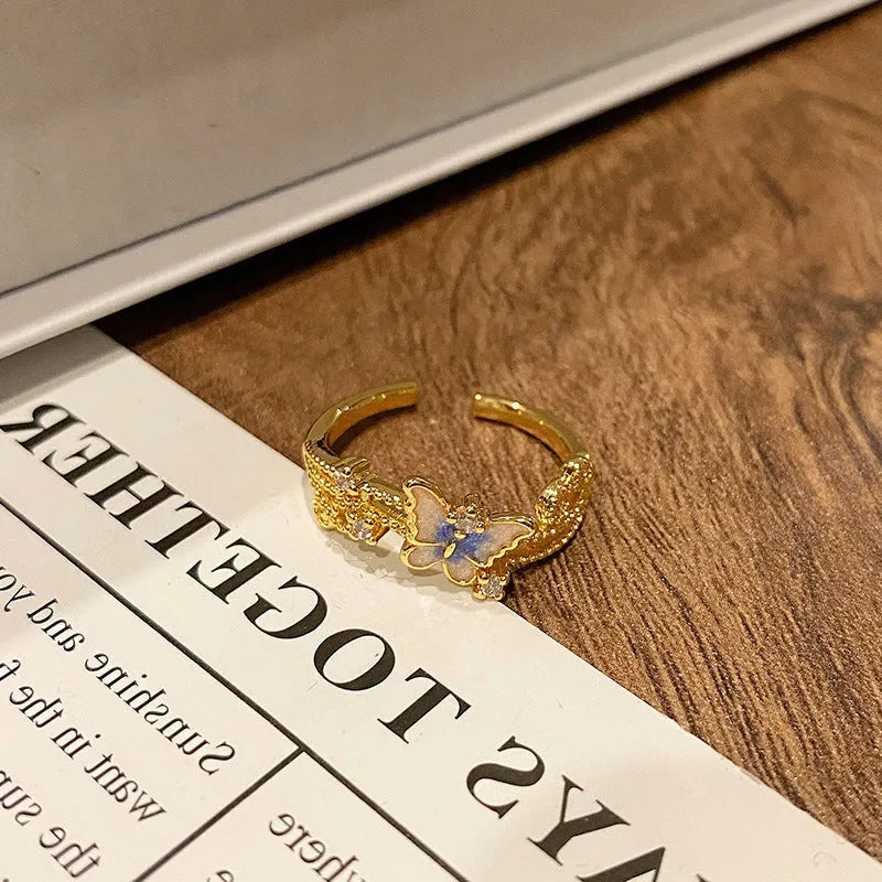 Copper butterfly women's ring with drip oil finish in an open-loop design.