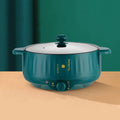 Stainless steel electric cooking pot with non-stick interior and integrated heating element