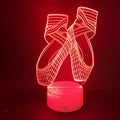 3D ballet shoes night light with colourful LED glow, showing remote control and USB cable.