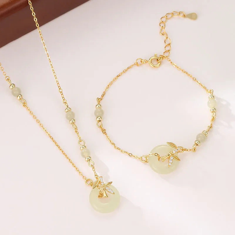 Women's antique style Hetian Jade bracelet with a silver safety buckle on a wrist.