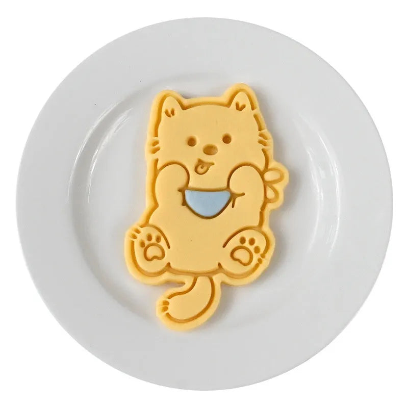 Three dimensional press plastic biscuit mould showing cartoon puppy designs