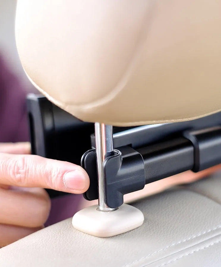 Black universal car phone holder mounted on a rear car seat, holding a tablet for navigation.