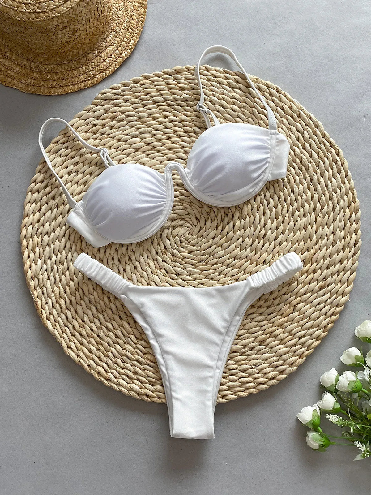 Women's black underwire bikini swimsuit with briefs on a neutral background
