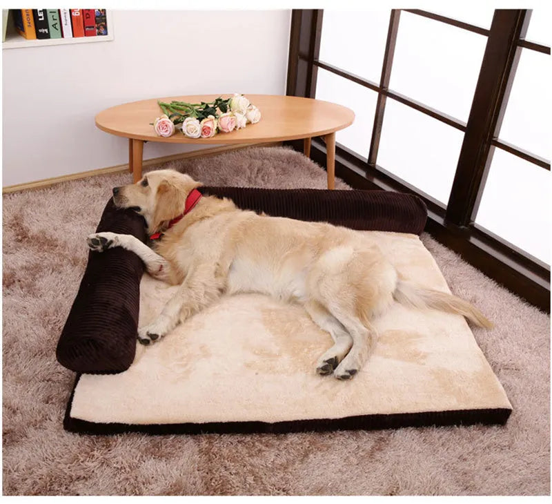 Grey corduroy dog sofa bed with bilateral bolsters on a wooden floor.