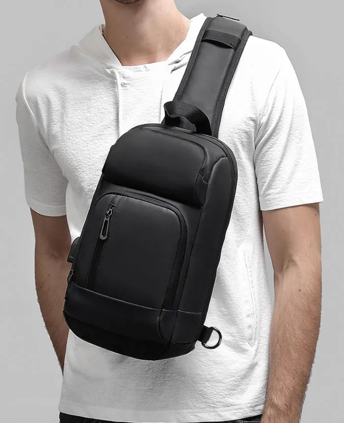Black PVC outdoor leisure shoulder bag with air cushion strap showing organisational pockets