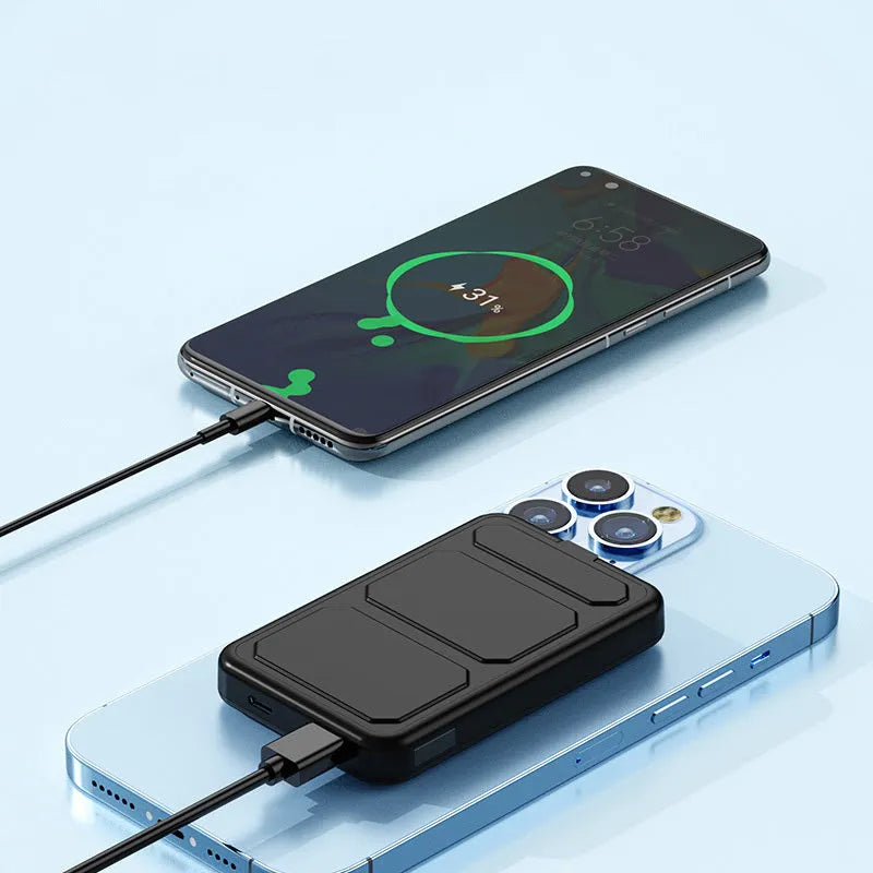 Magnetic wireless charging power bank with folding stand open, showing colour options on a table.