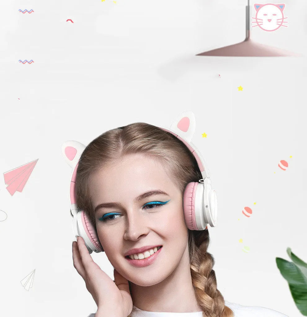 Pink and white wireless Bluetooth over-ear headphones with protein ear cushions and braided charging cable
