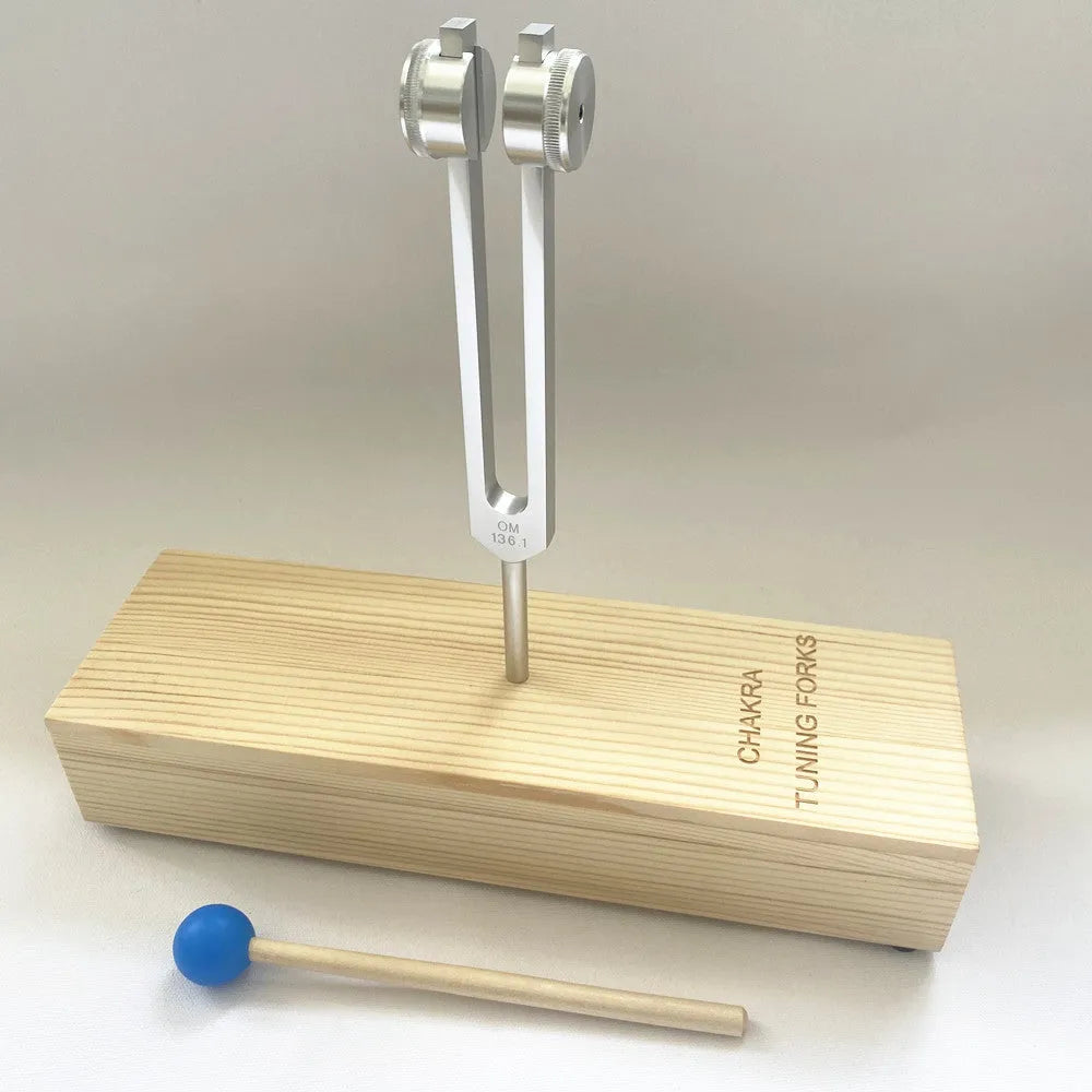 Aluminium alloy 432 Hz tuning fork with built-in speaker on kraft paper box.