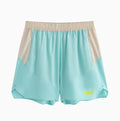 Men's loose grey workout shorts with elastic waist and lace-up fly on a gym floor.