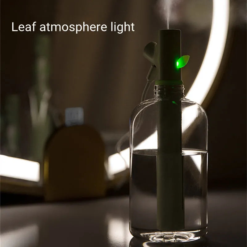 Transparent plastic portable USB humidifier on a desk with mist output