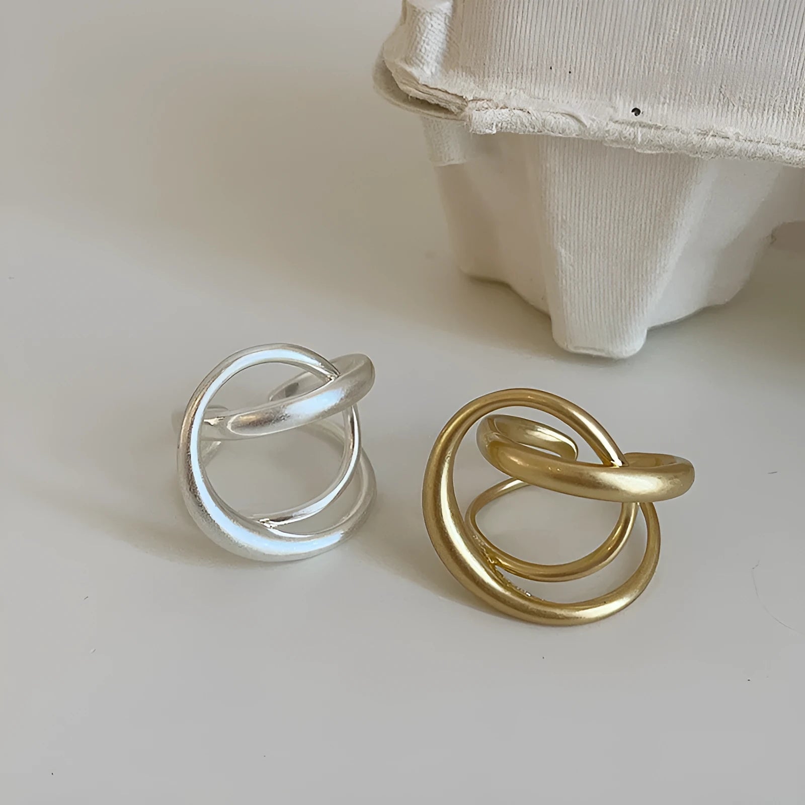 Geometric open ring with three-dimensional interlaced matte metal design and gold electroplating