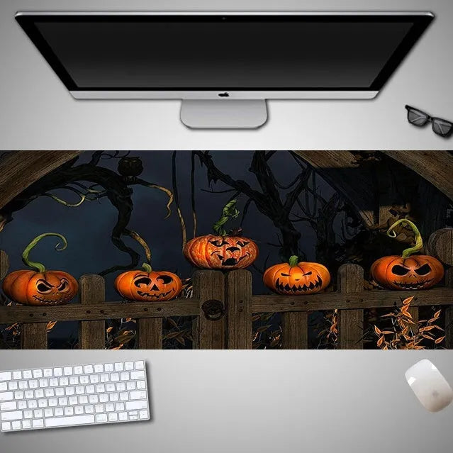 Oversized Halloween pattern mouse pad on a desk showing non-slip rubber base and cloth top.
