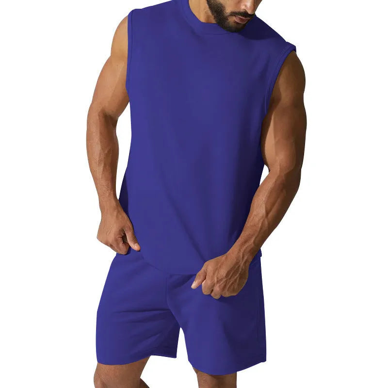 Man wearing a sleeveless army green top and matching shorts from a casual cotton blend sports suit set.