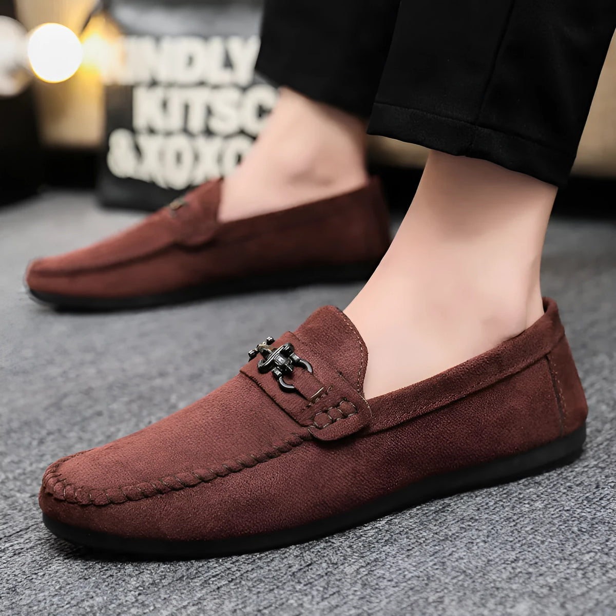 Men's black slip-on loafers with round toe and low heel on a white background