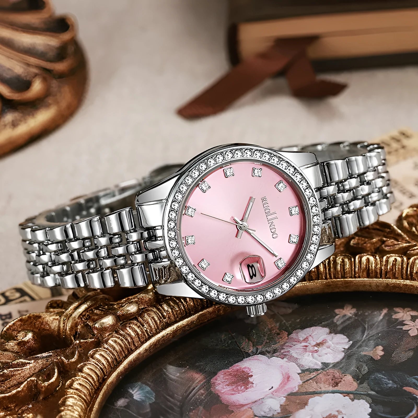 Women's silver alloy quartz watch with calendar display on a wrist