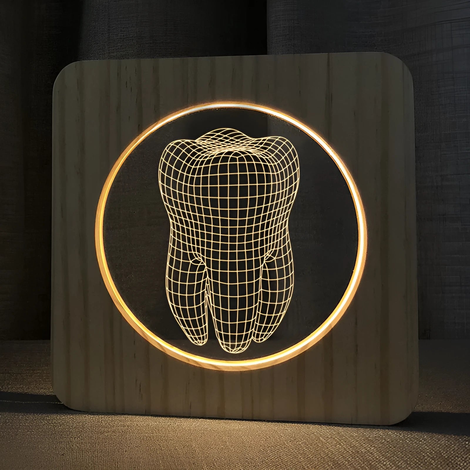 Tooth-shaped wooden-coloured acrylic night lamp with USB cable on wooden surface