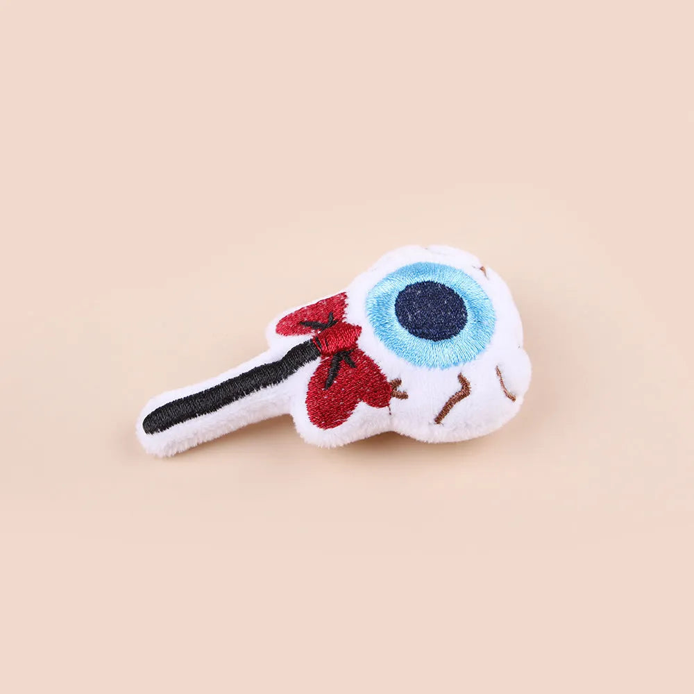 Small cat teaser wand with candy, eyes and skull plush attachments