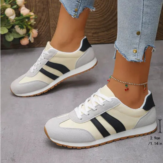 Blue and grey leisure sports shoes with Cortez stripes pattern, round toe, and flat rubber sole.