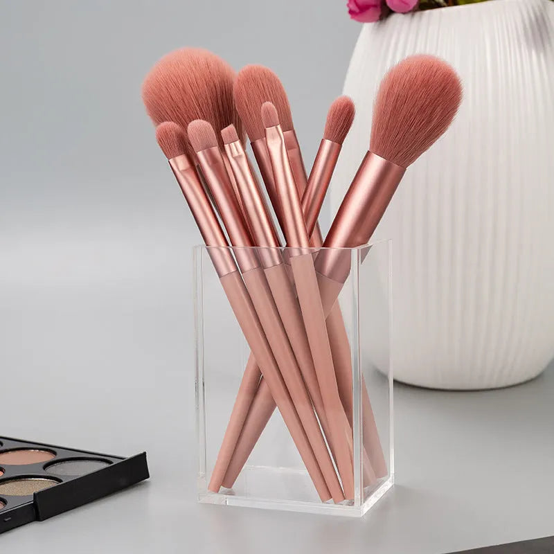 8-piece pink makeup brush set with man-made fibre heads and portable plastic handles, no bag included