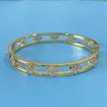 Women's hollow bracelet with a four-leaf clover zircon charm on an adjustable band, shown in gold and silver finishes.