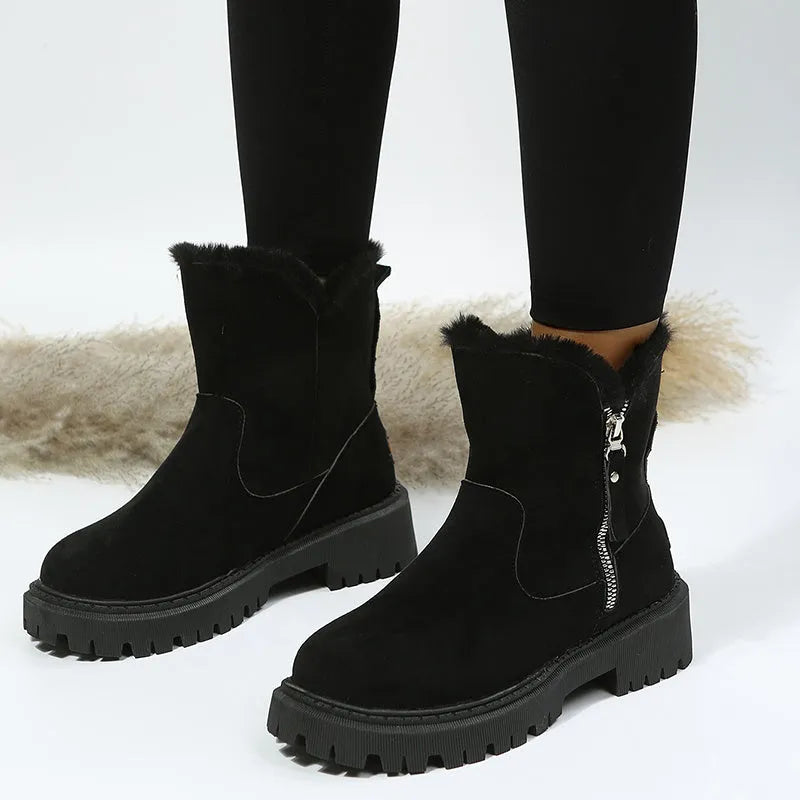 Women's black high-top snow boots with faux suede uppers, side zipper, and fluffy fur lining.