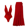 Red women's V-neck halter swimsuit with detachable flower and matching long skirt on a white background.