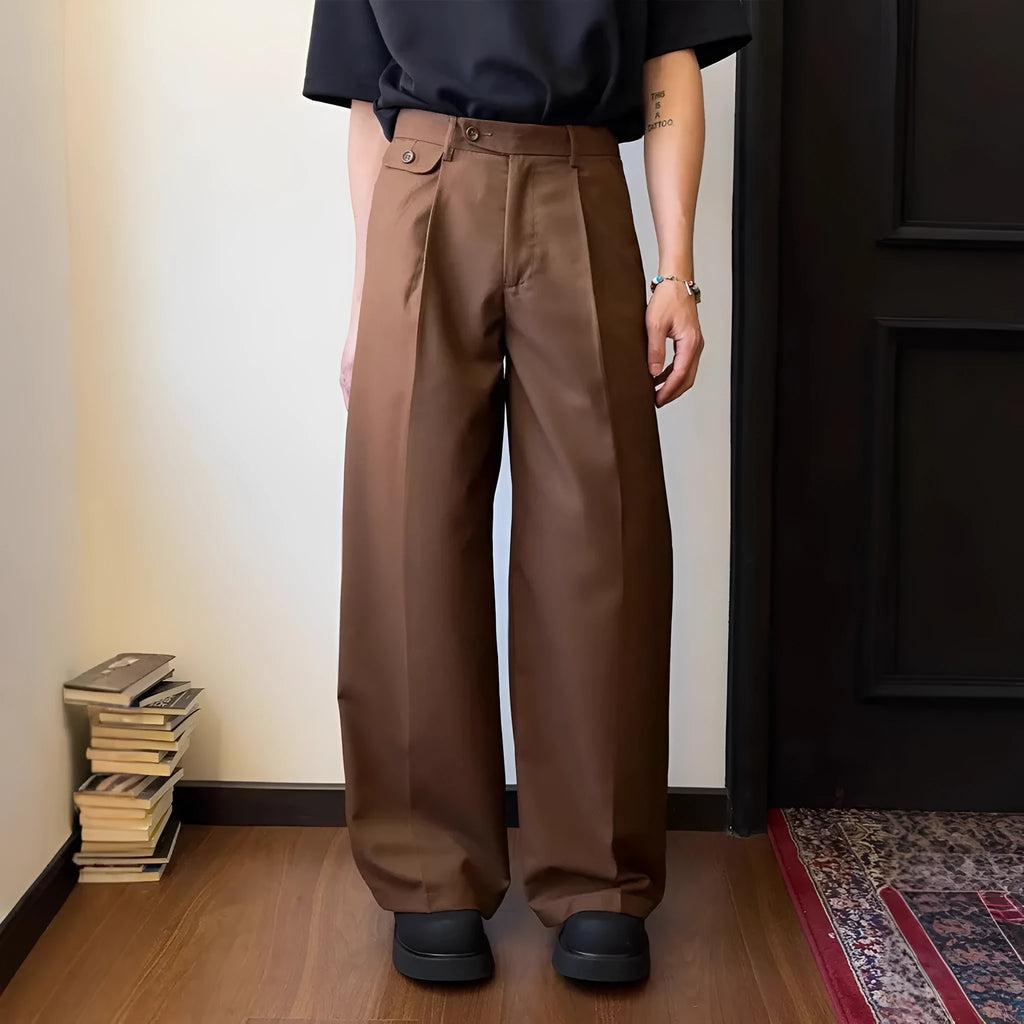 Men's loose-fitting straight-leg trousers in brown and black colours on a hanger