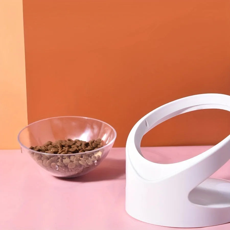 Clear plastic tilted cat food bowl for ergonomic feeding and neck protection