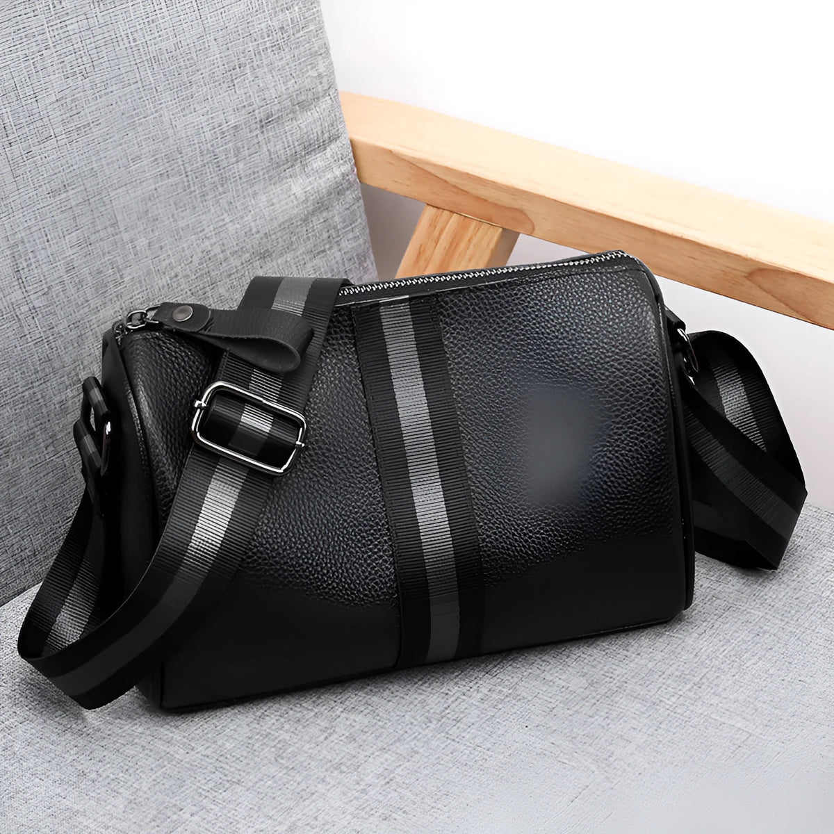 Black genuine leather one-shoulder crossbody bag showing front view and adjustable strap.
