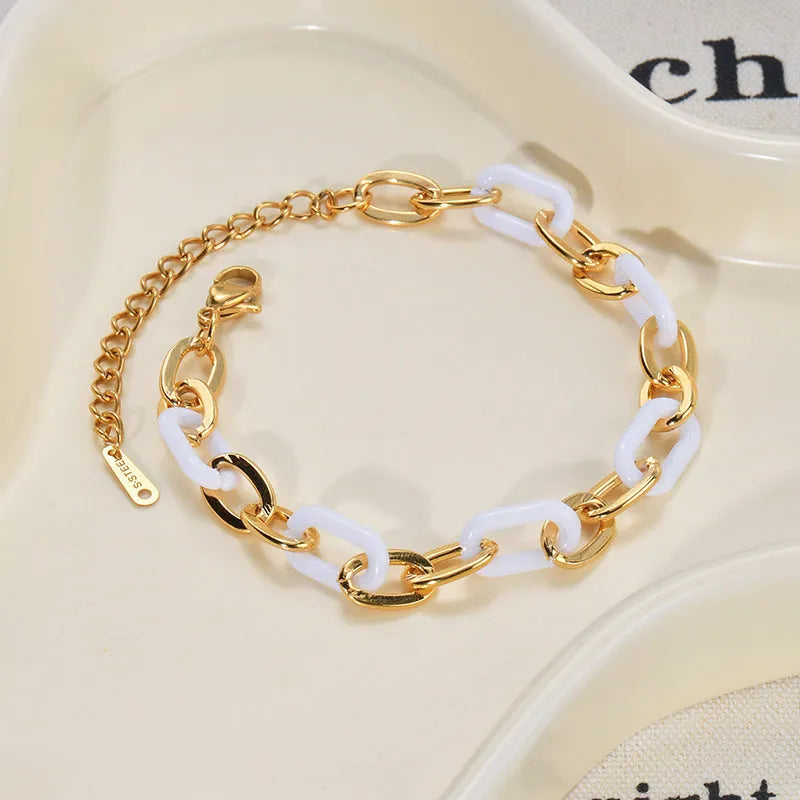 Women's stainless steel bracelet with electroplated finish and a double-layered resin heart charm.