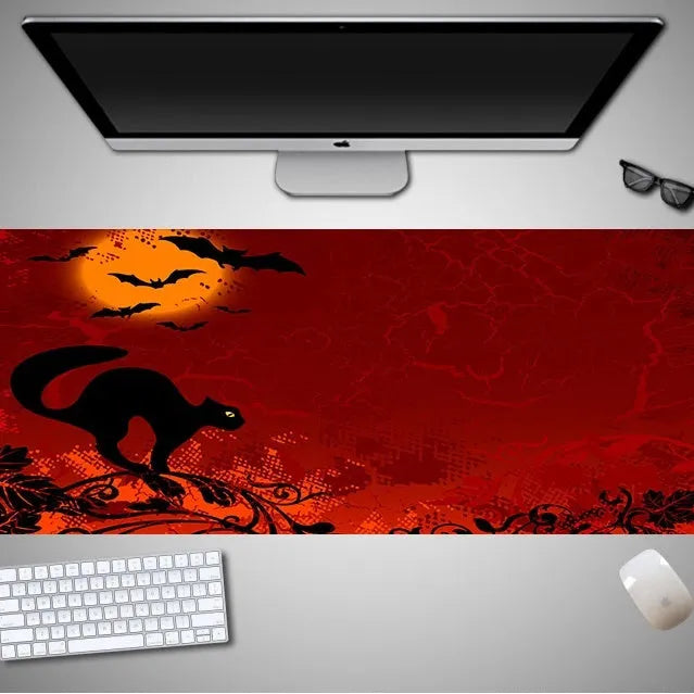 Oversized Halloween pattern mouse pad on a desk showing non-slip rubber base and cloth top.