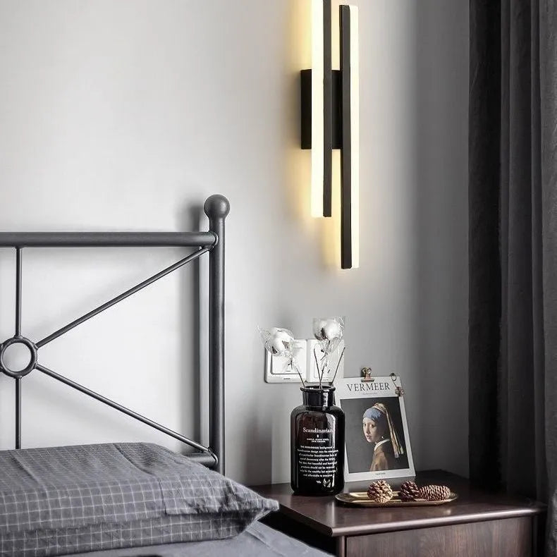 Scandinavian minimalist LED wall light with an acrylic shade on a black arm, mounted on a light-coloured wall.