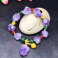 Women's amethyst bead bracelet with natural-shaped stones and fu character charm on adjustable beaded design