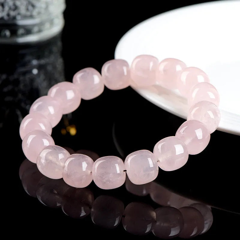 Pink bamboo crystal barrel bead bracelet with geometric design on wrist