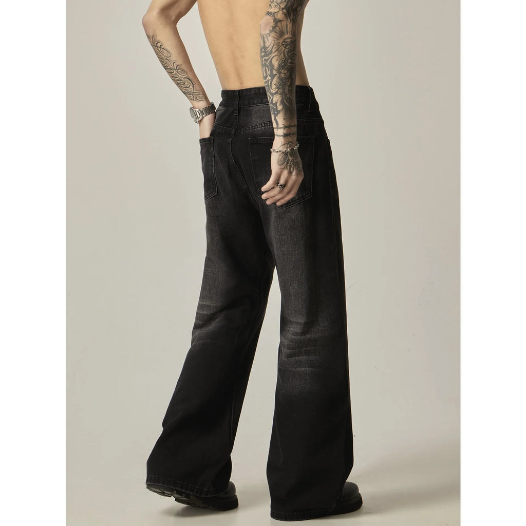 Black loose-fit straight-leg retro jeans with a zipper fly on a mannequin.