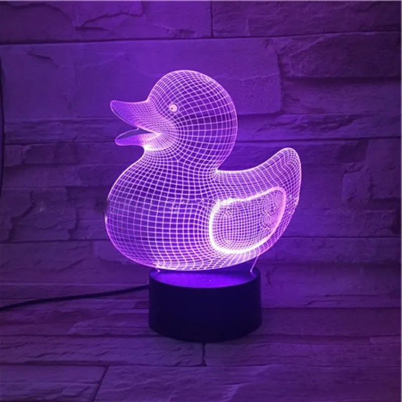 Little yellow duck 3D night light with remote control on a bedside table, showing colour change