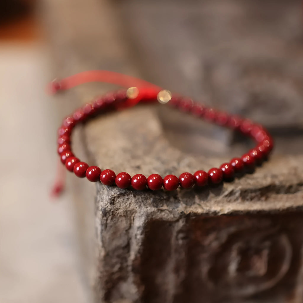 Handcrafted natural cinnabar bracelet with purple gold sand geometric design and auspicious Chinese patterns