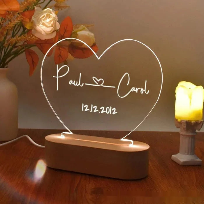 Custom couple names and date engraved on a transparent acrylic LED night light.