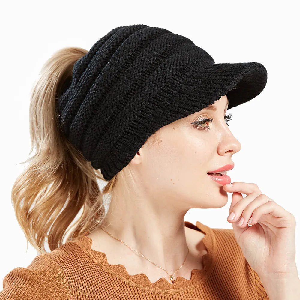 Women's soft acrylic ponytail beanie hat in various colours on a model with a ponytail.