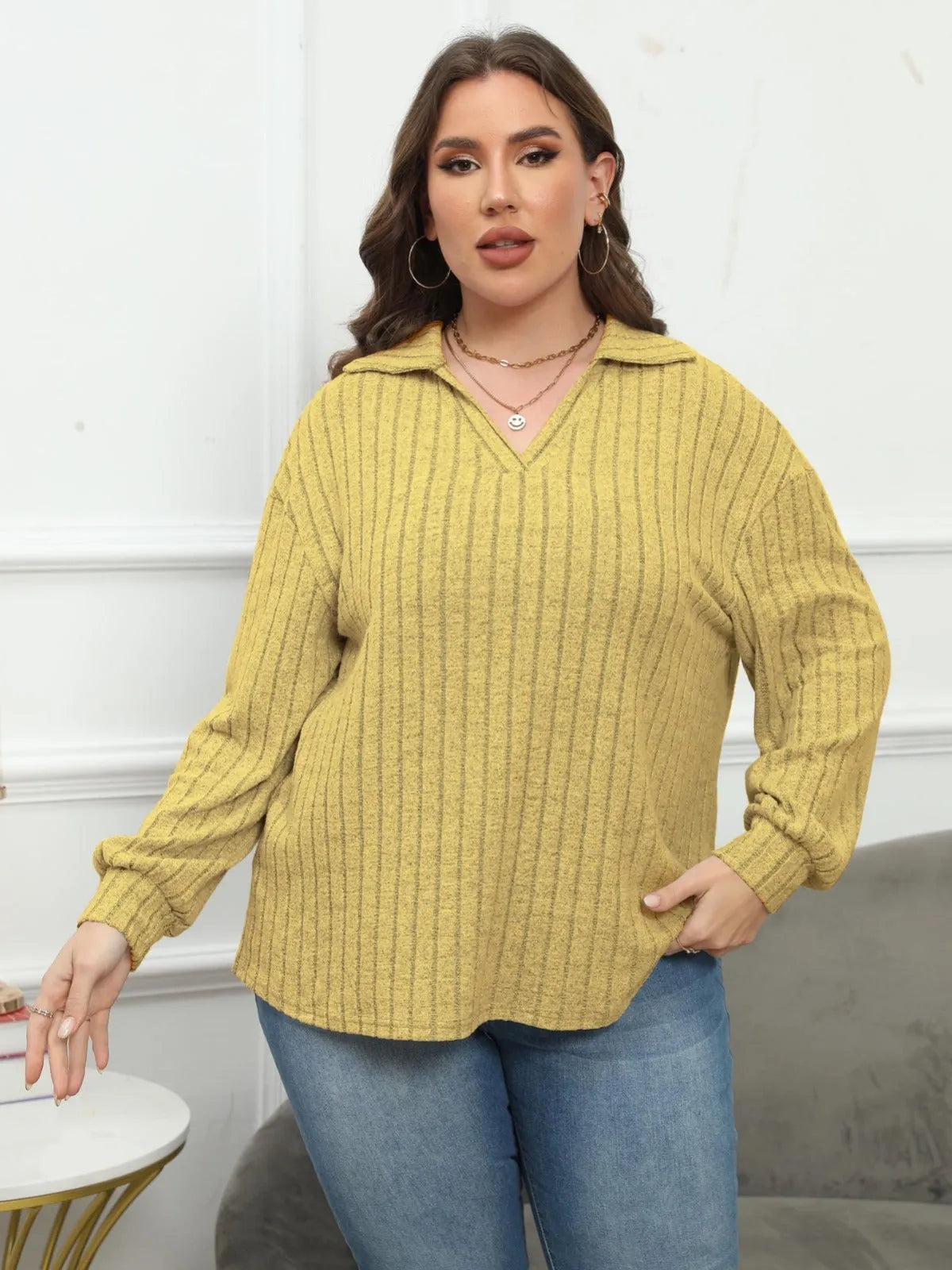 Women's plus size gray polo collar fleece shirt with lantern sleeves on a hanger.
