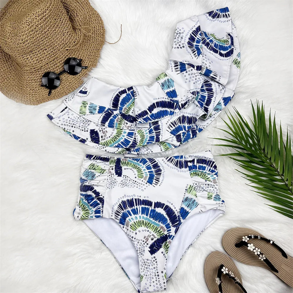 White women's one-shoulder swimsuit with large lotus leaf design and side split