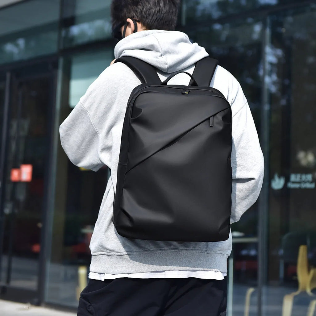 Large waterproof backpack in PU leather available in black, blue, or grey colours