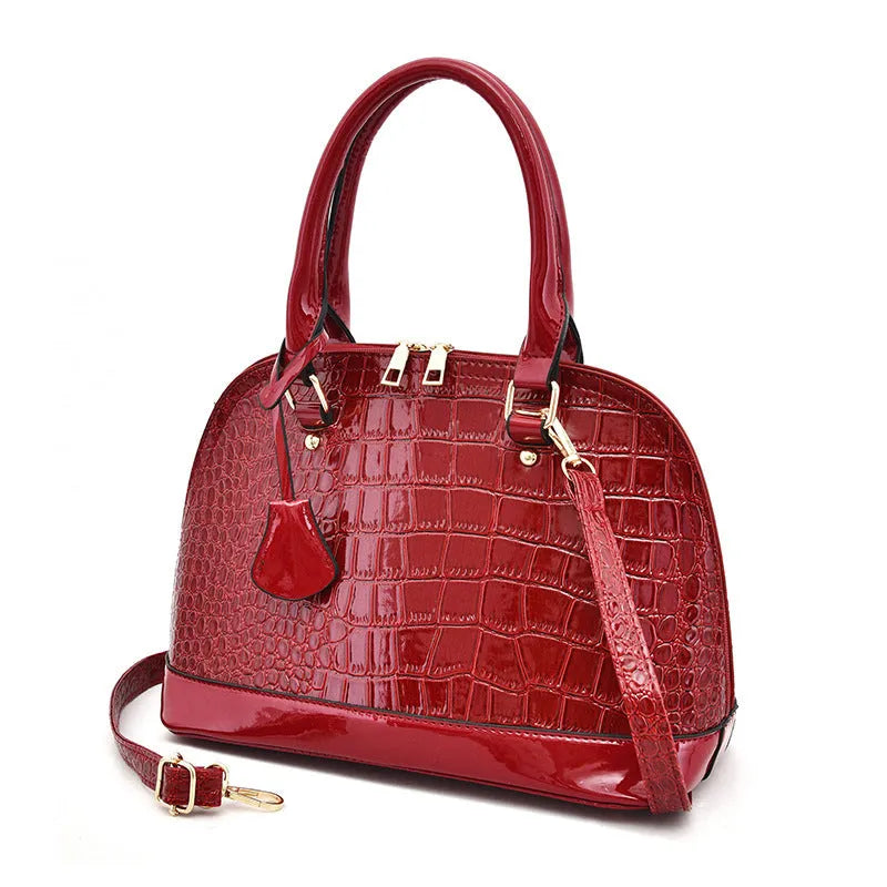 Glossy PU leather crossbody shoulder bag in shell shape with structured design