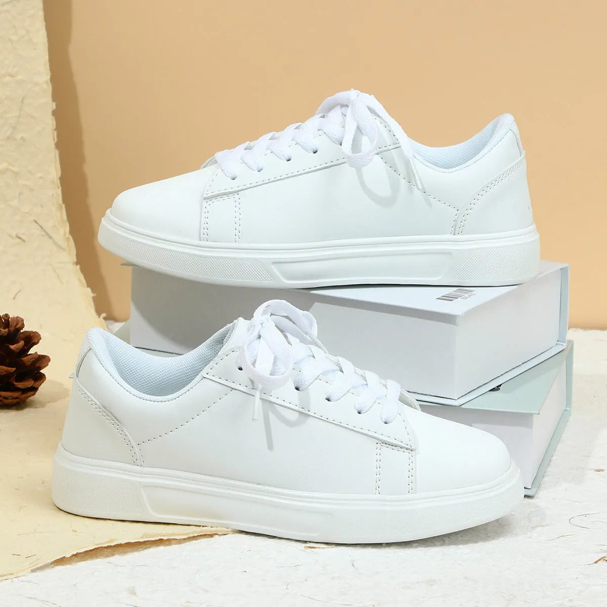 Women's platform skateboard sneakers with cross-strap detailing and mid-heel sole